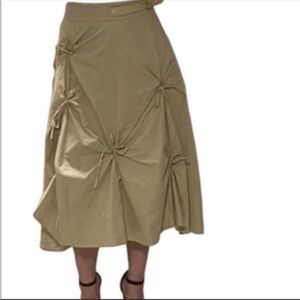 Tan midi skirt with front lace up bows and side belt detail. Size small.